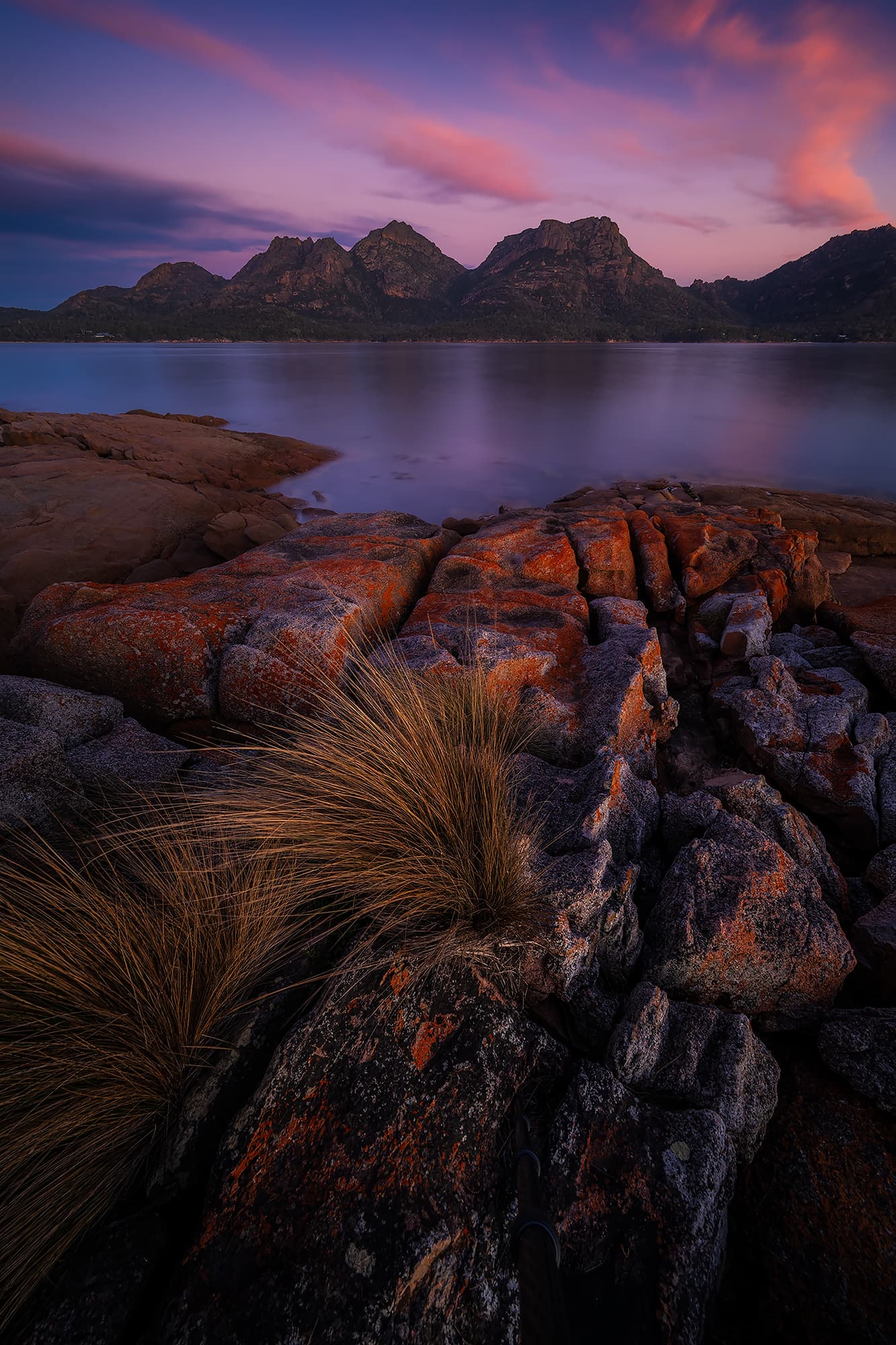 Soft pastel tones over a calm bay at Coles Bay, Tasmania