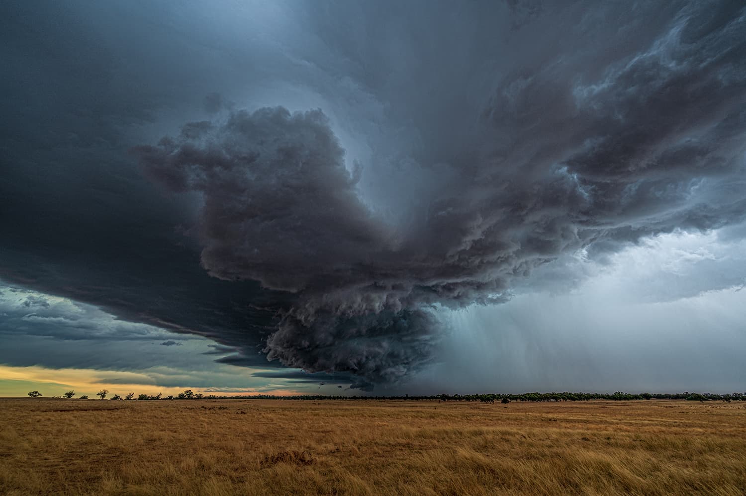 A brooding storm cell building over the landscape