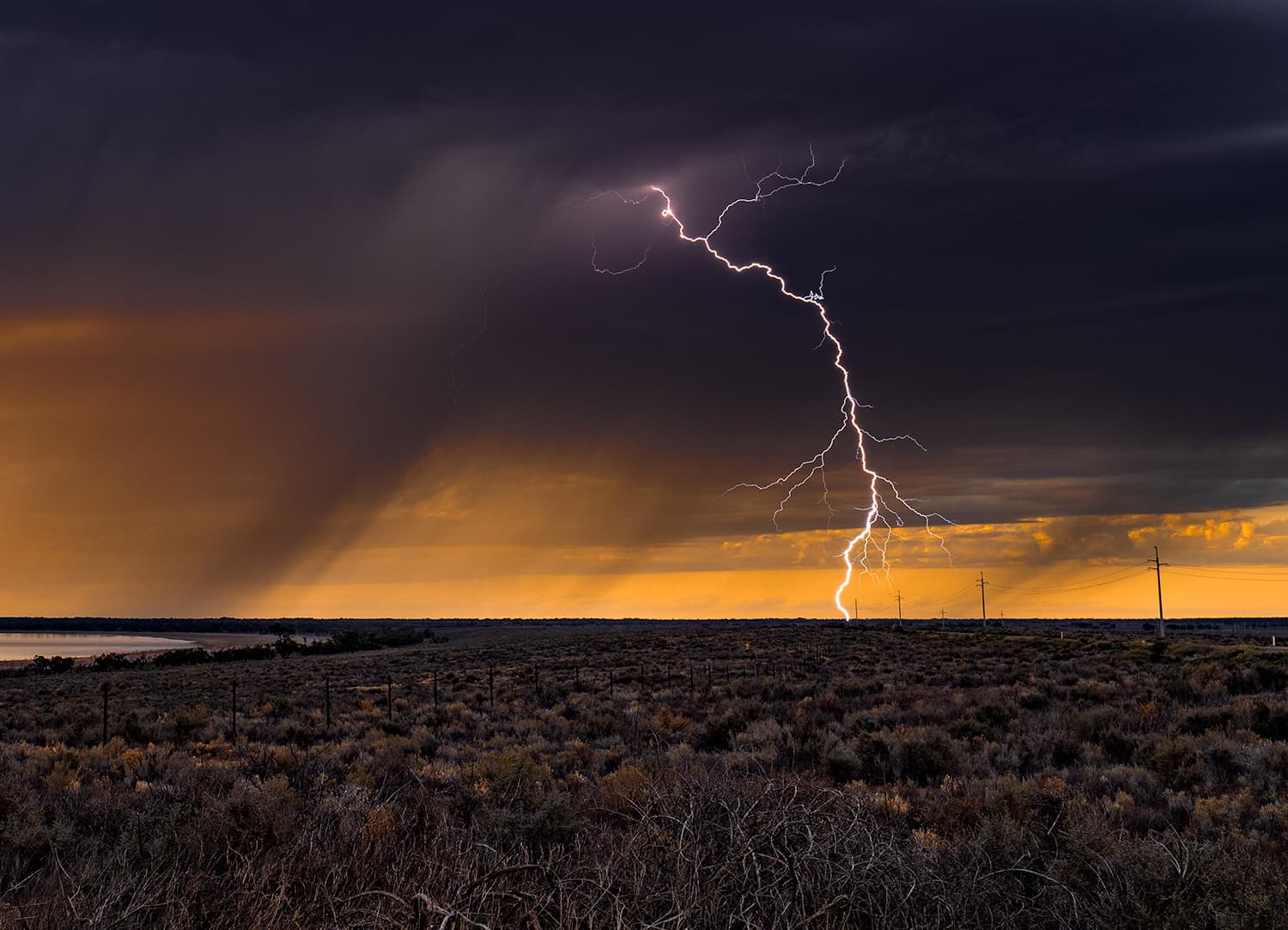 Lightning strike illuminating the sky at dusk